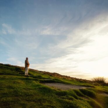 Person looking at a sunset representing SMSF succession and estate planning