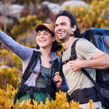 Hiking,,travel,and,couple,pointing,on,mountain,for,adventure,,holiday